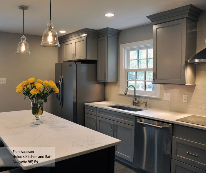 Gray cabinets with a dark blue kitchen island